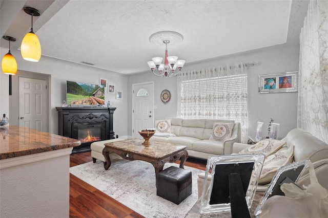 living room featuring a chandelier and hardwood / wood-style floors