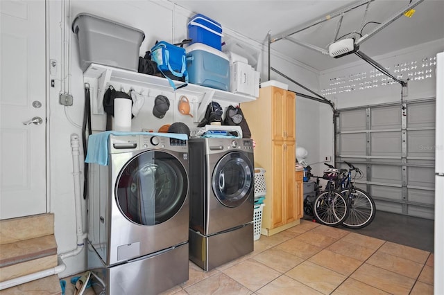 clothes washing area with washer and clothes dryer and light tile patterned floors