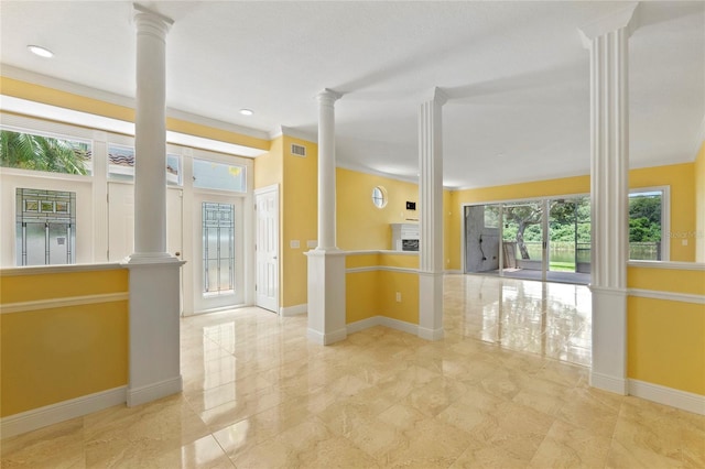 empty room with decorative columns and crown molding