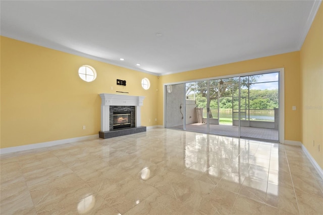 unfurnished living room featuring baseboards, marble finish floor, a stone fireplace, and ornamental molding