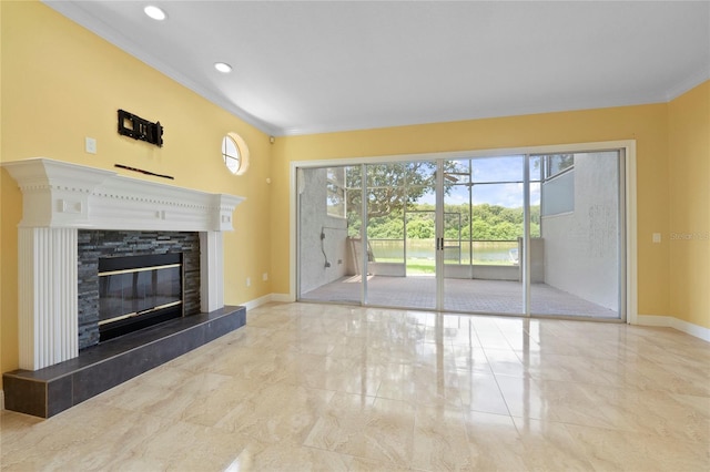 unfurnished living room featuring plenty of natural light and ornamental molding