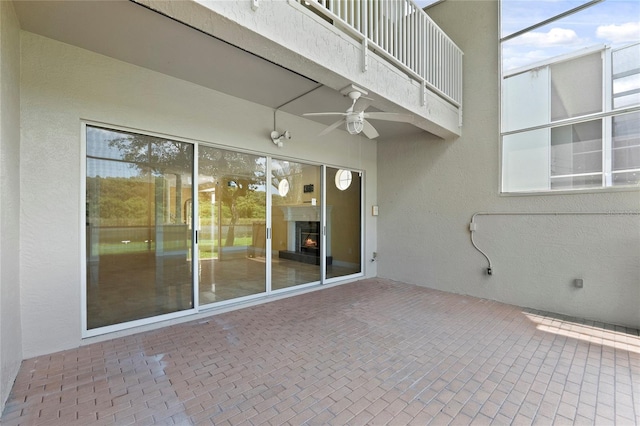 view of patio featuring ceiling fan and a balcony