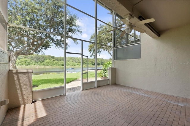 unfurnished sunroom with a ceiling fan