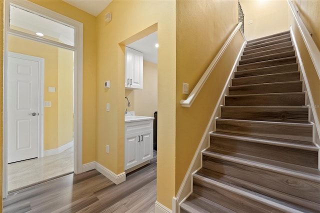 stairs with wood-type flooring