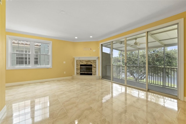 unfurnished living room featuring crown molding, ceiling fan, and a fireplace