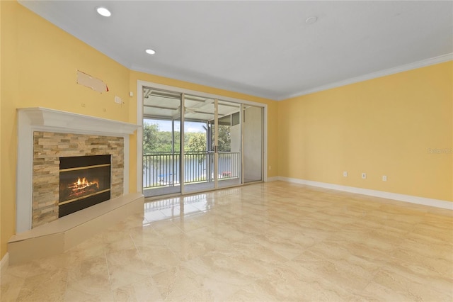 unfurnished living room featuring crown molding and a stone fireplace