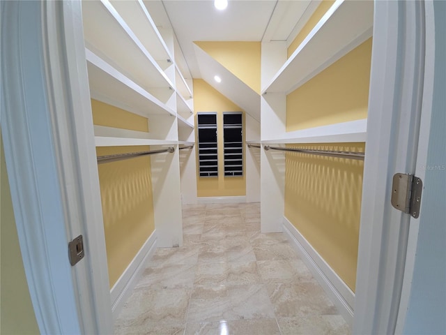 walk in closet with marble finish floor