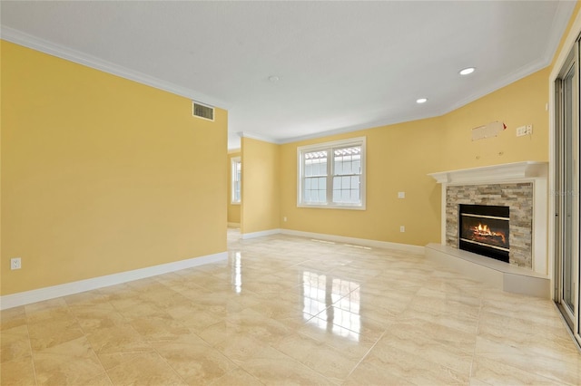 unfurnished living room featuring baseboards, a fireplace, visible vents, and ornamental molding