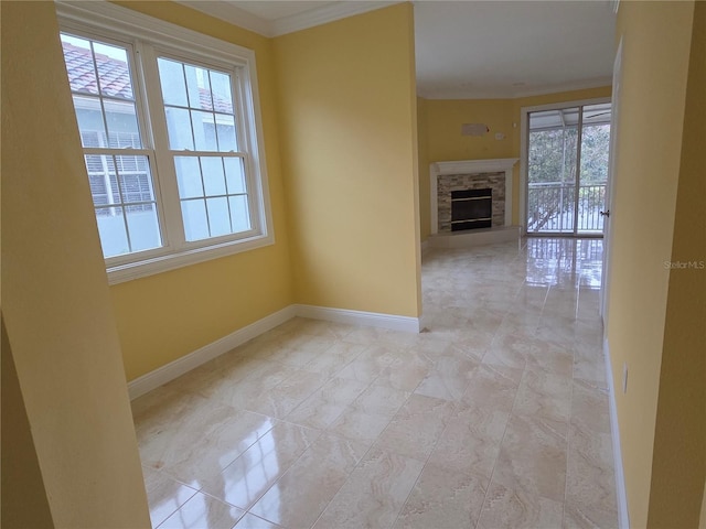 spare room with baseboards, a fireplace, and crown molding