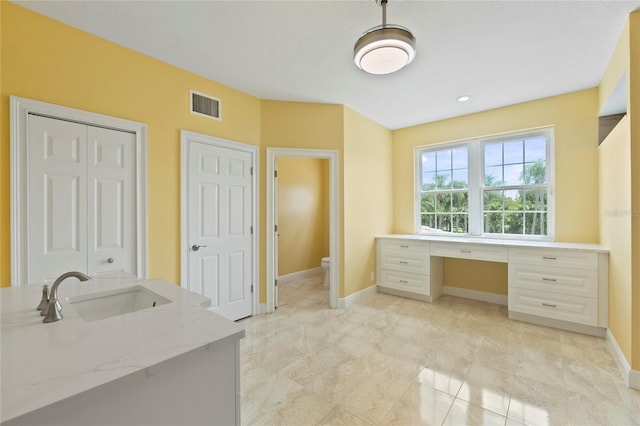 bathroom with vanity, toilet, baseboards, and visible vents