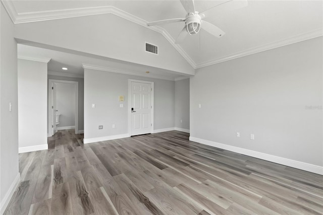 spare room with visible vents, lofted ceiling, a ceiling fan, and crown molding