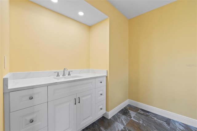 bathroom featuring recessed lighting, baseboards, and vanity