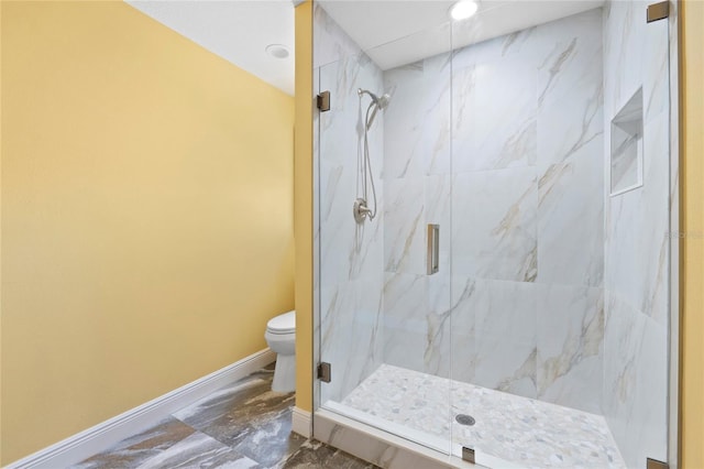 bathroom with toilet, marble finish floor, baseboards, and a marble finish shower