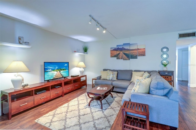 living room featuring hardwood / wood-style flooring and rail lighting