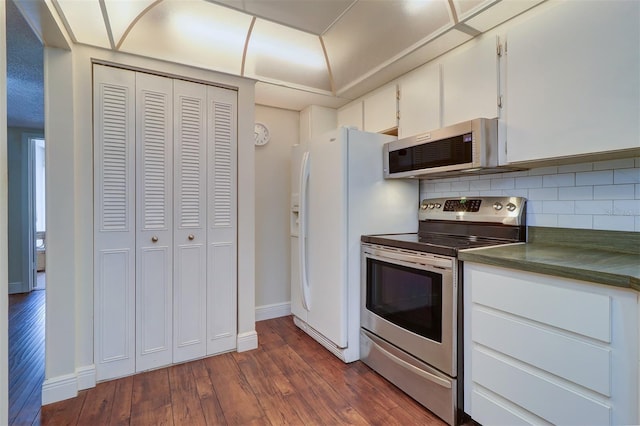 kitchen featuring white cabinetry, appliances with stainless steel finishes, dark hardwood / wood-style floors, and tasteful backsplash