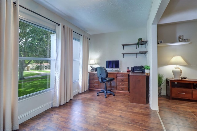 office with dark hardwood / wood-style floors and a textured ceiling