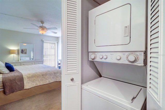 washroom with carpet, ceiling fan, and stacked washing maching and dryer