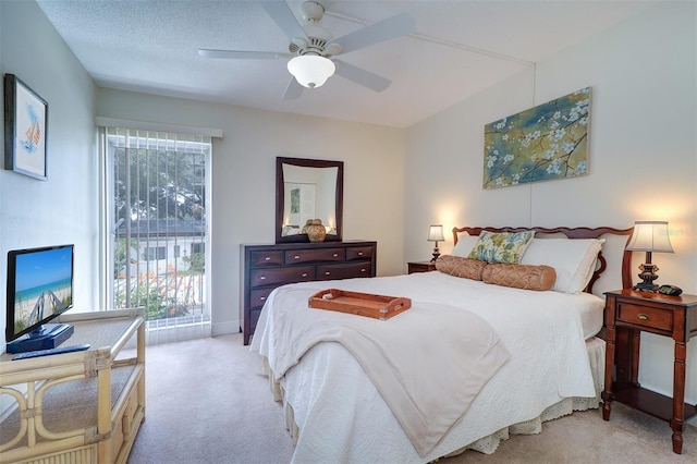 carpeted bedroom with multiple windows, a textured ceiling, and ceiling fan