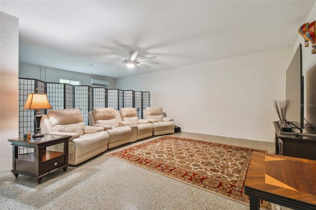 living room featuring a wall unit AC and ceiling fan