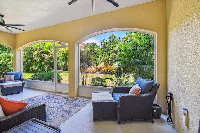 sunroom / solarium featuring ceiling fan and a healthy amount of sunlight