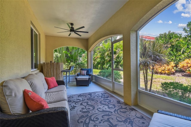 sunroom / solarium featuring ceiling fan