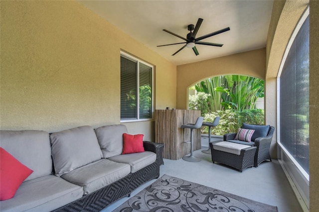 sunroom / solarium featuring ceiling fan