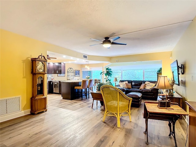 living room featuring ceiling fan and light wood-type flooring