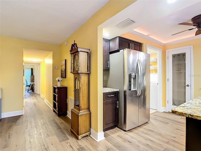 kitchen featuring light stone counters, stainless steel fridge with ice dispenser, dark brown cabinets, light wood-type flooring, and ceiling fan