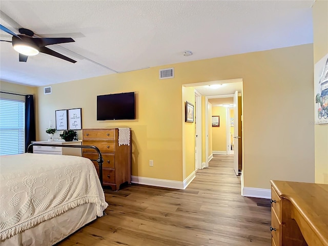 bedroom with ceiling fan and light hardwood / wood-style flooring