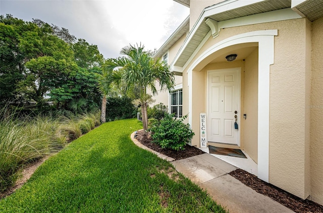 doorway to property with a yard