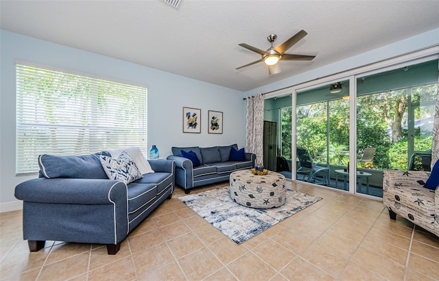 living room featuring ceiling fan and light tile patterned flooring