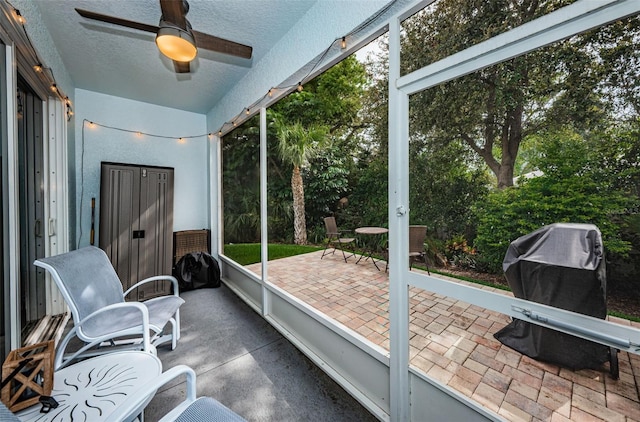 sunroom featuring ceiling fan