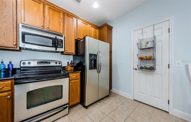 kitchen featuring light tile patterned floors and appliances with stainless steel finishes