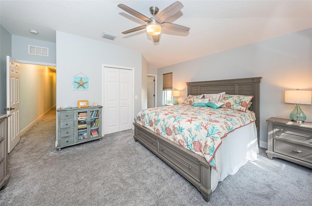 carpeted bedroom with vaulted ceiling, ceiling fan, and a closet