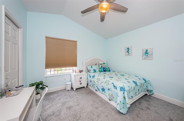 bedroom featuring ceiling fan, lofted ceiling, a closet, and carpet floors