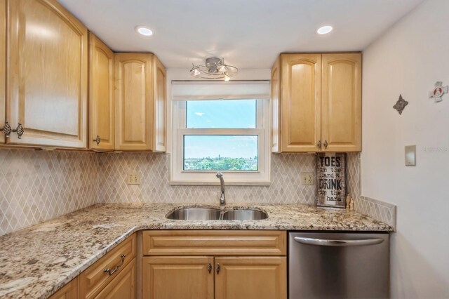 kitchen featuring sink, light stone counters, light brown cabinets, backsplash, and stainless steel dishwasher