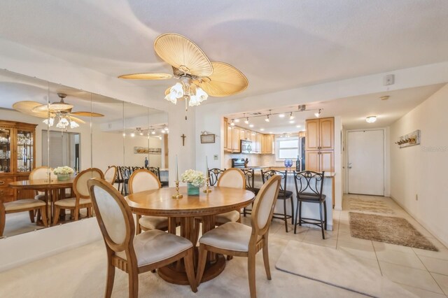 tiled dining room featuring ceiling fan