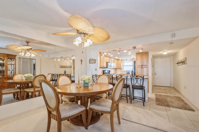 dining area with light tile patterned floors and ceiling fan