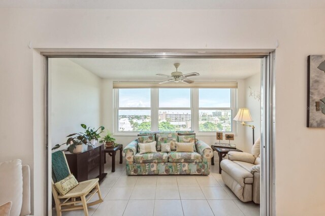 living room with light tile patterned flooring and ceiling fan