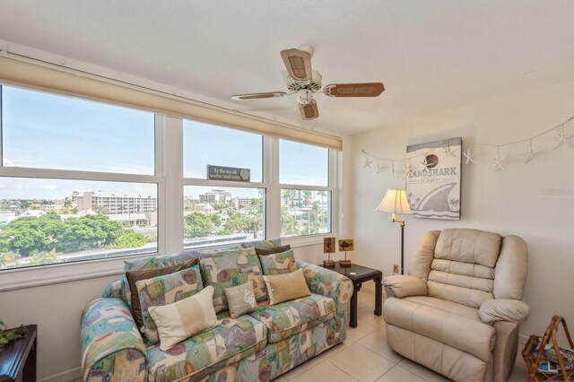 tiled living room with ceiling fan