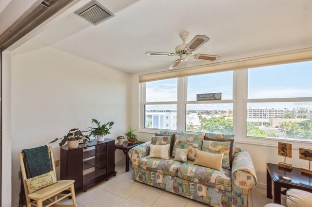 tiled living room featuring a wealth of natural light and ceiling fan