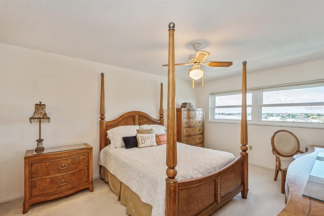 carpeted bedroom with a textured ceiling and ceiling fan