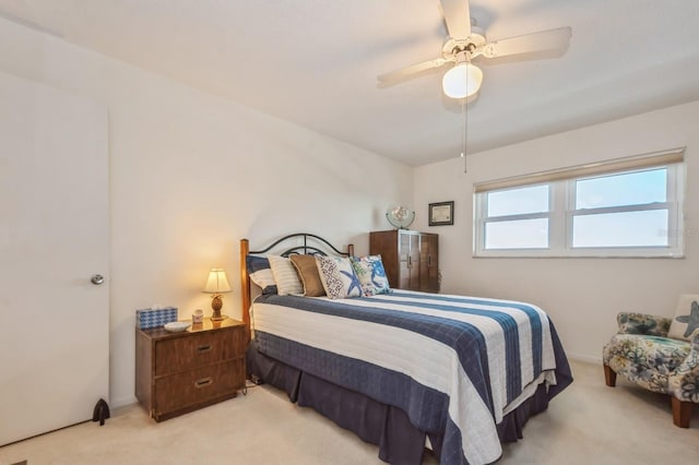 bedroom featuring light colored carpet and ceiling fan