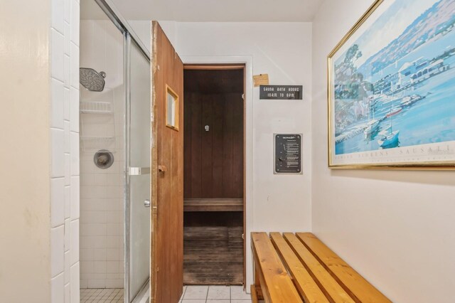 bathroom featuring a shower with shower door and tile patterned flooring