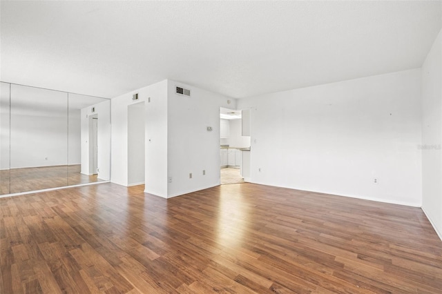 unfurnished living room featuring hardwood / wood-style flooring