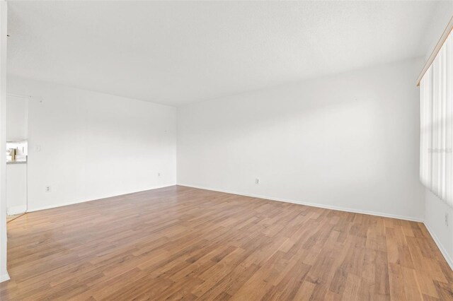 unfurnished room with a wealth of natural light and light hardwood / wood-style floors