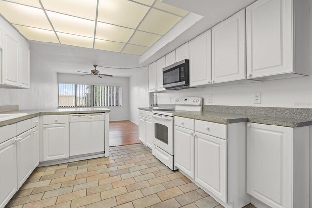 kitchen with white cabinetry, light tile patterned floors, ceiling fan, white appliances, and kitchen peninsula