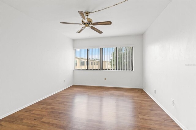 unfurnished room with hardwood / wood-style flooring and ceiling fan