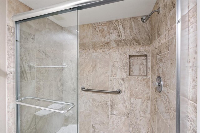 bathroom with a shower with door