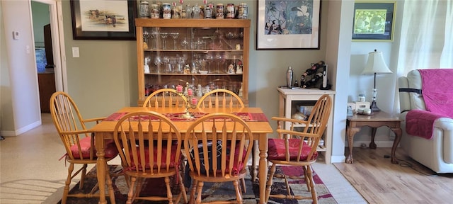 dining room with bar and hardwood / wood-style flooring